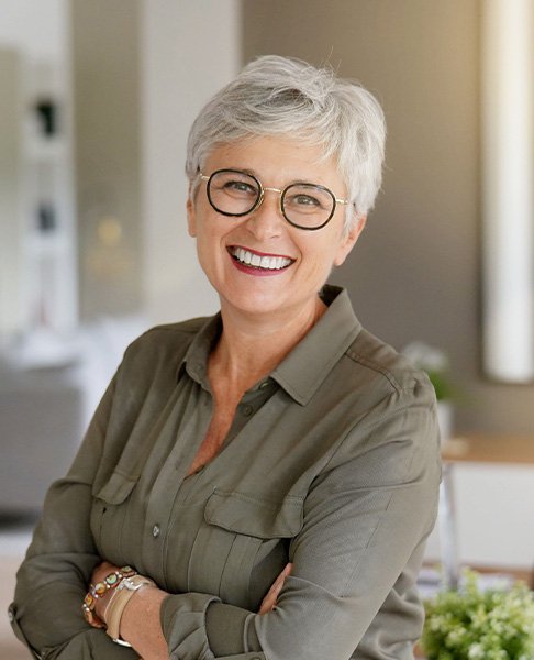 Senior woman smiling with arms folded