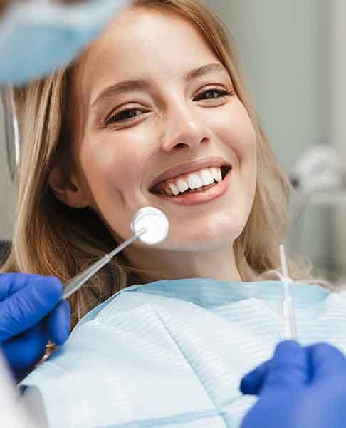 patient smiling while visiting dentist 