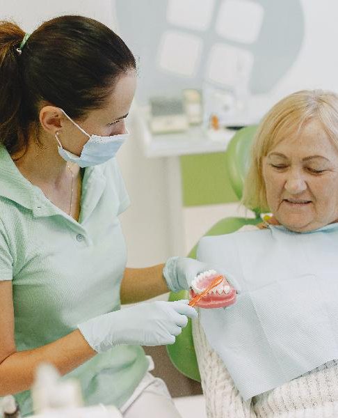 Dentist discussing denture care with dentist