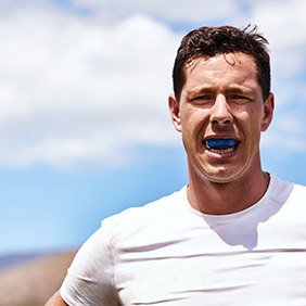 Patient in Glendale with dental implants wearing a mouthguard