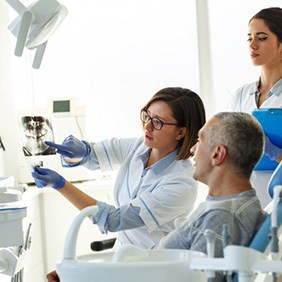 Patient in Glendale smiling with dental implants at dentist